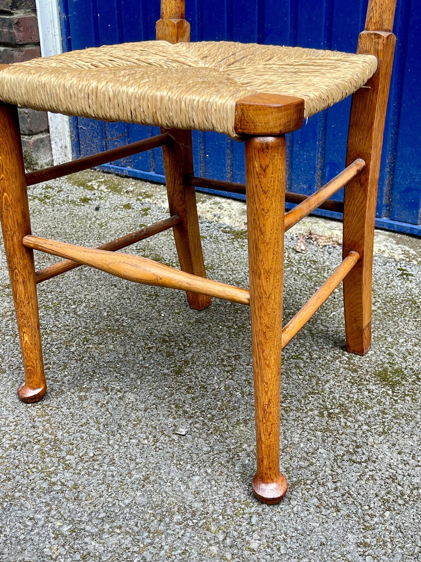 A Set Of Five Arts And Crafts Oak Rush-Seated Ladder Back Dining Chairs