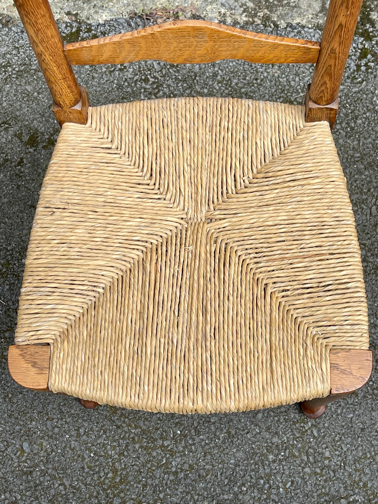 A Set Of Five Arts And Crafts Oak Rush-Seated Ladder Back Dining Chairs