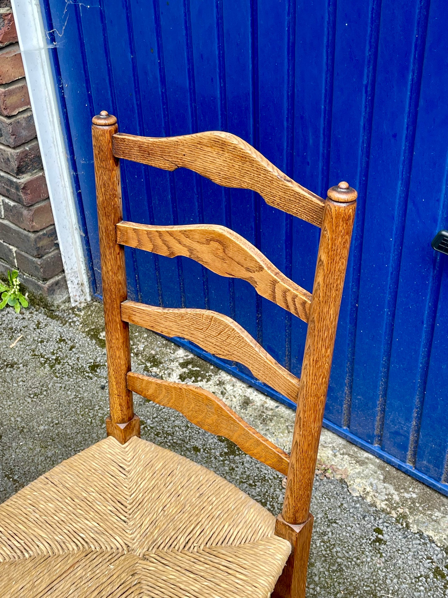 A Set Of Five Arts And Crafts Oak Rush-Seated Ladder Back Dining Chairs